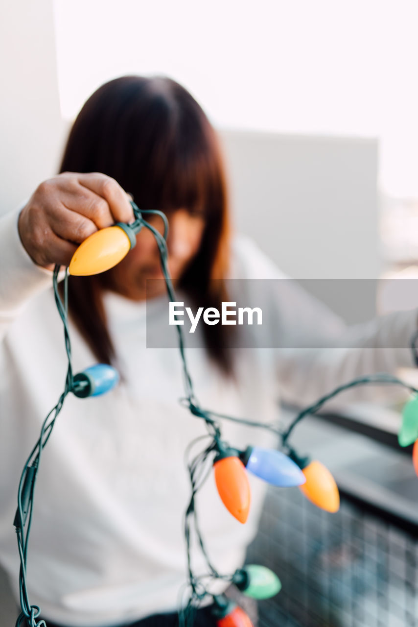 Woman holding colorful lighting equipment