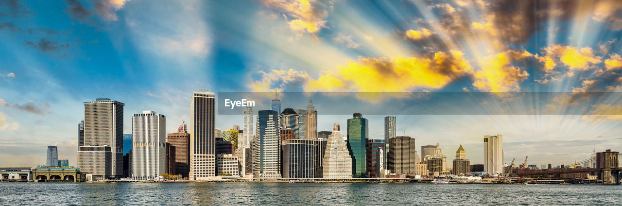 Panoramic view of sea and buildings against sky