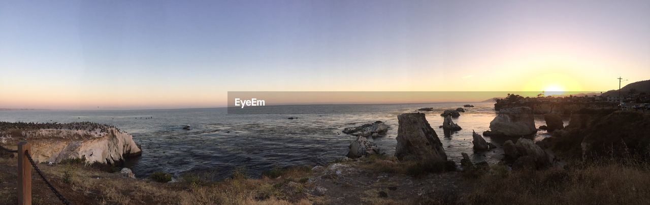 SCENIC VIEW OF SEA AGAINST SKY AT SUNSET