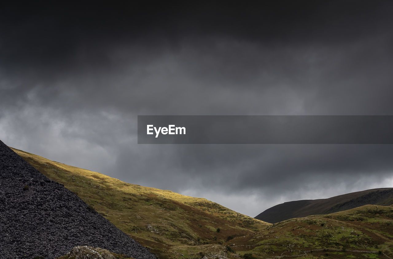 Scenic view of mountain against cloudy sky
