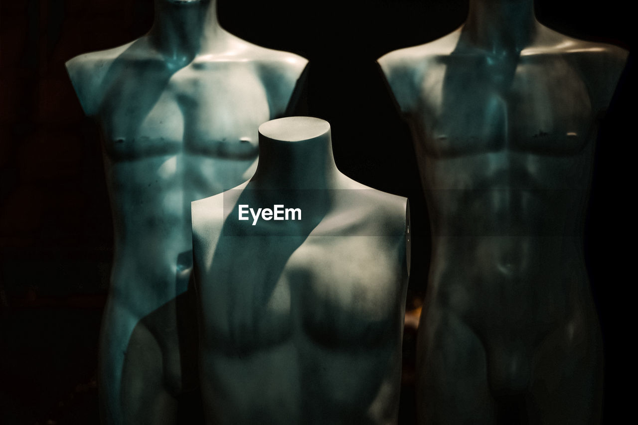 Close-up of mannequins in darkroom