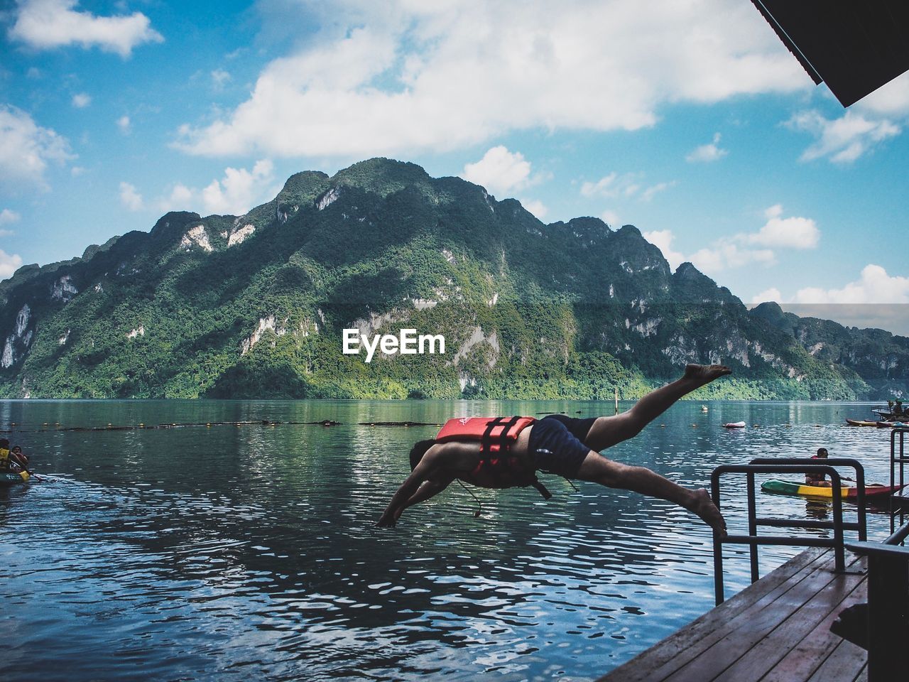 MAN IN LAKE AGAINST SKY