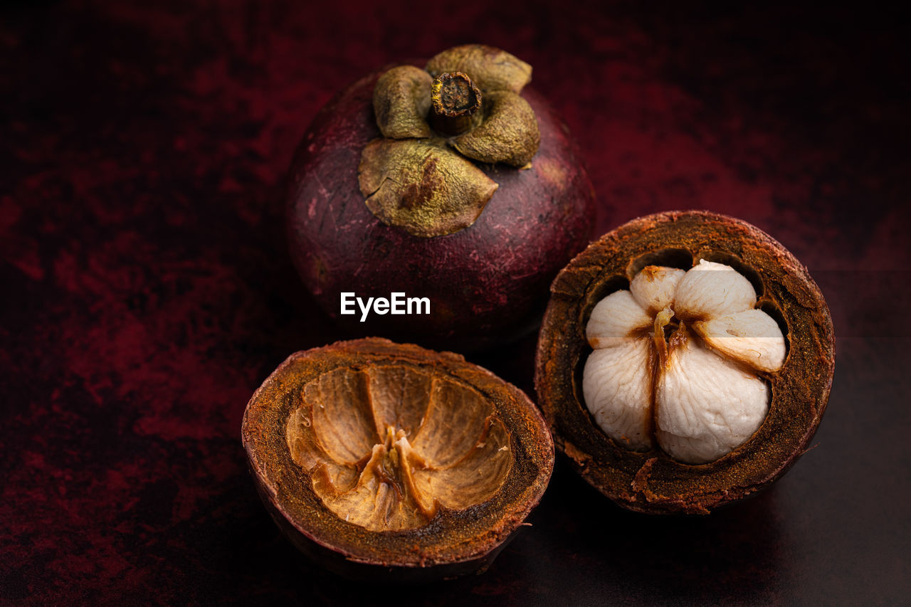 Closeup of mangosteen fruit on red background