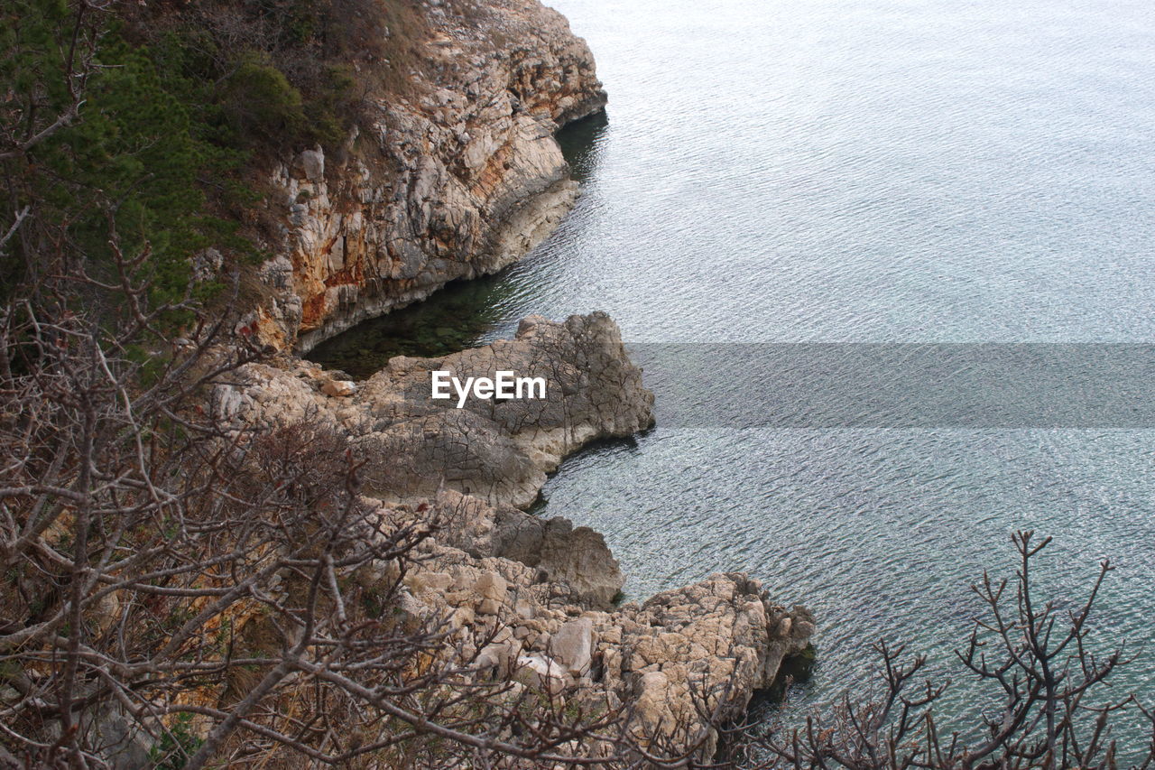 High angle view of rocks on sea shore