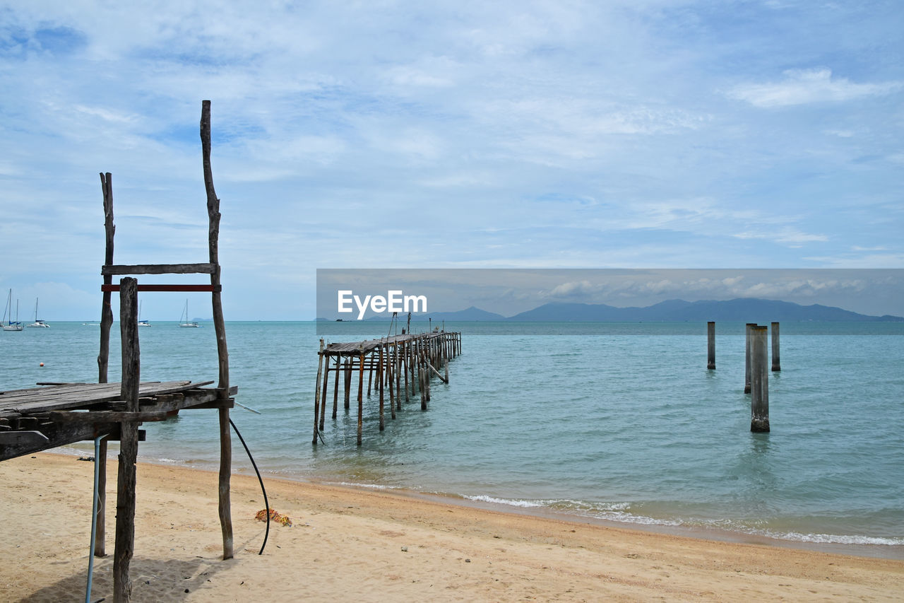 Scenic view of calm sea against cloudy sky