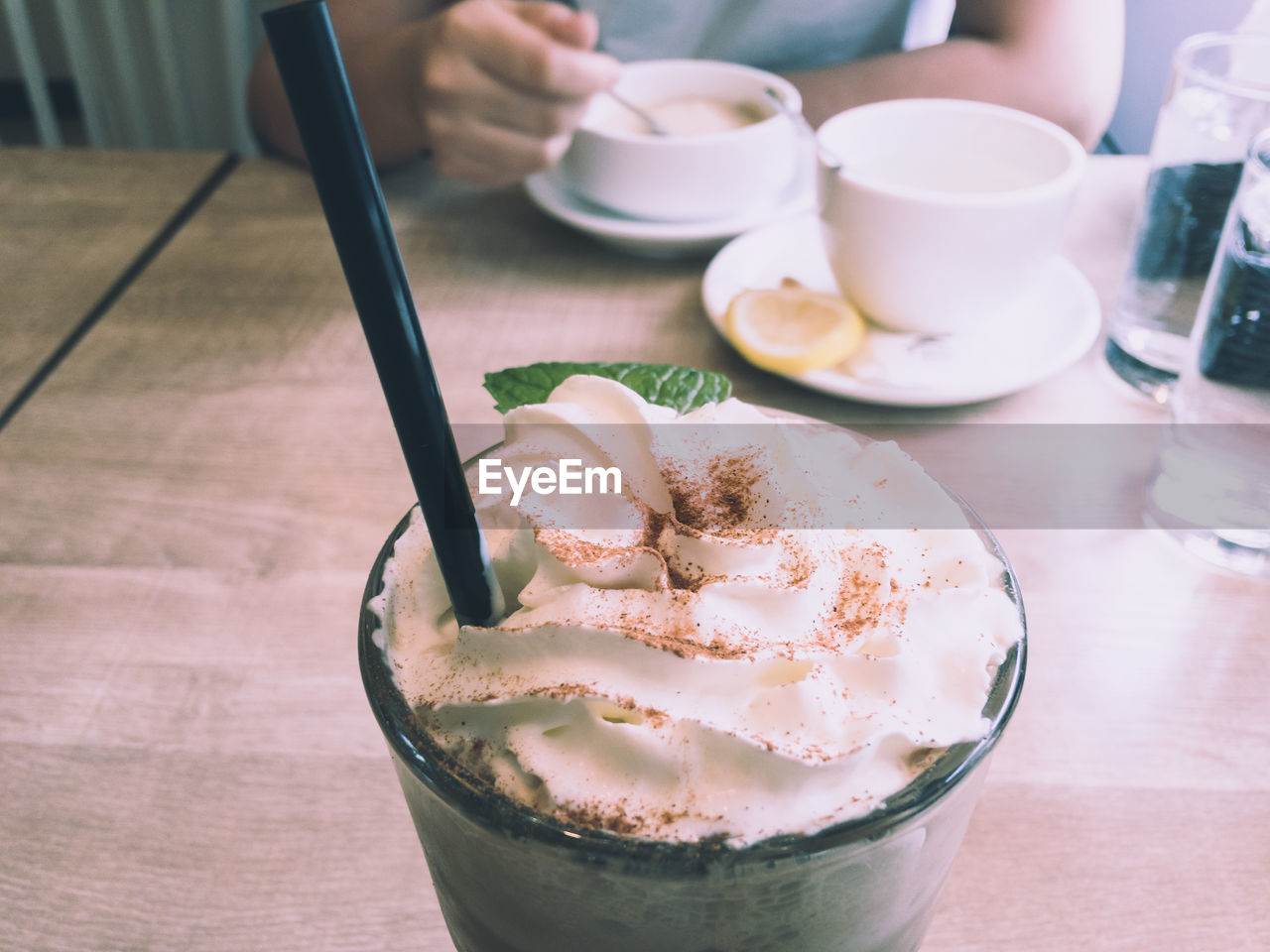 Midsection of coffee cup on table