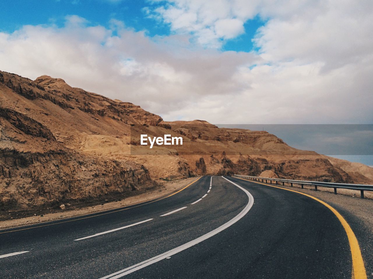 Empty road with mountains in background