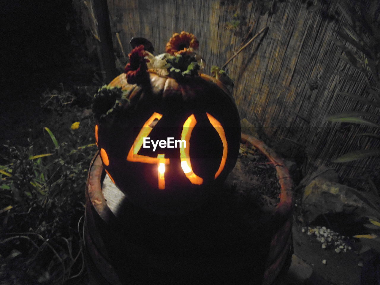 CLOSE-UP OF ILLUMINATED HALLOWEEN PUMPKIN