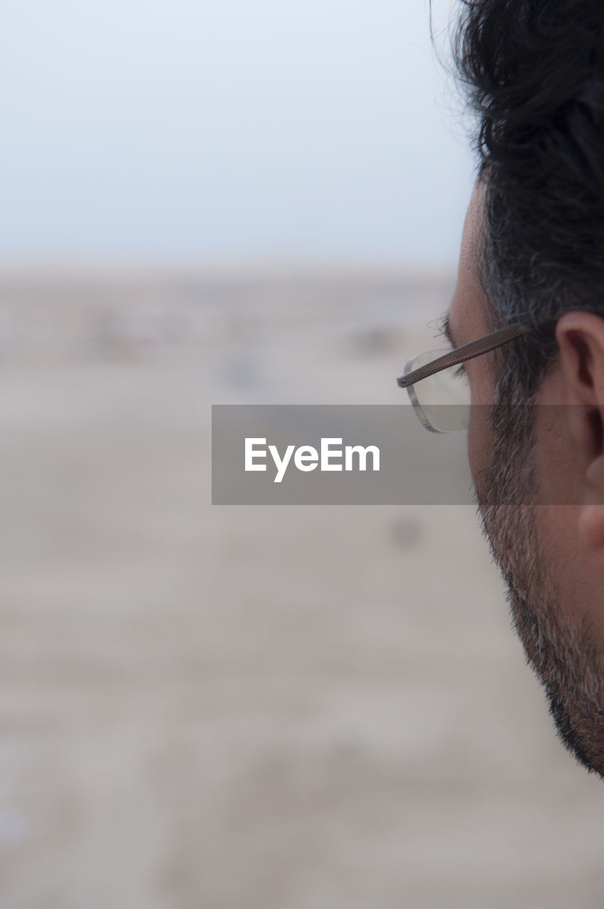 Close-up of senior man wearing eyeglasses on field