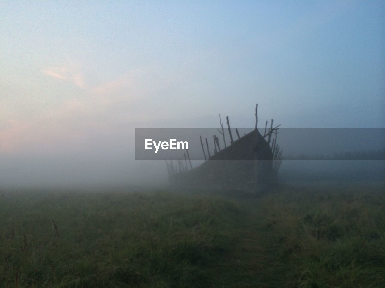 Damaged boat on field