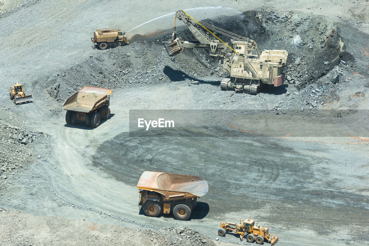 Electric rope shovel loading a dump trucks at a copper mine in chile