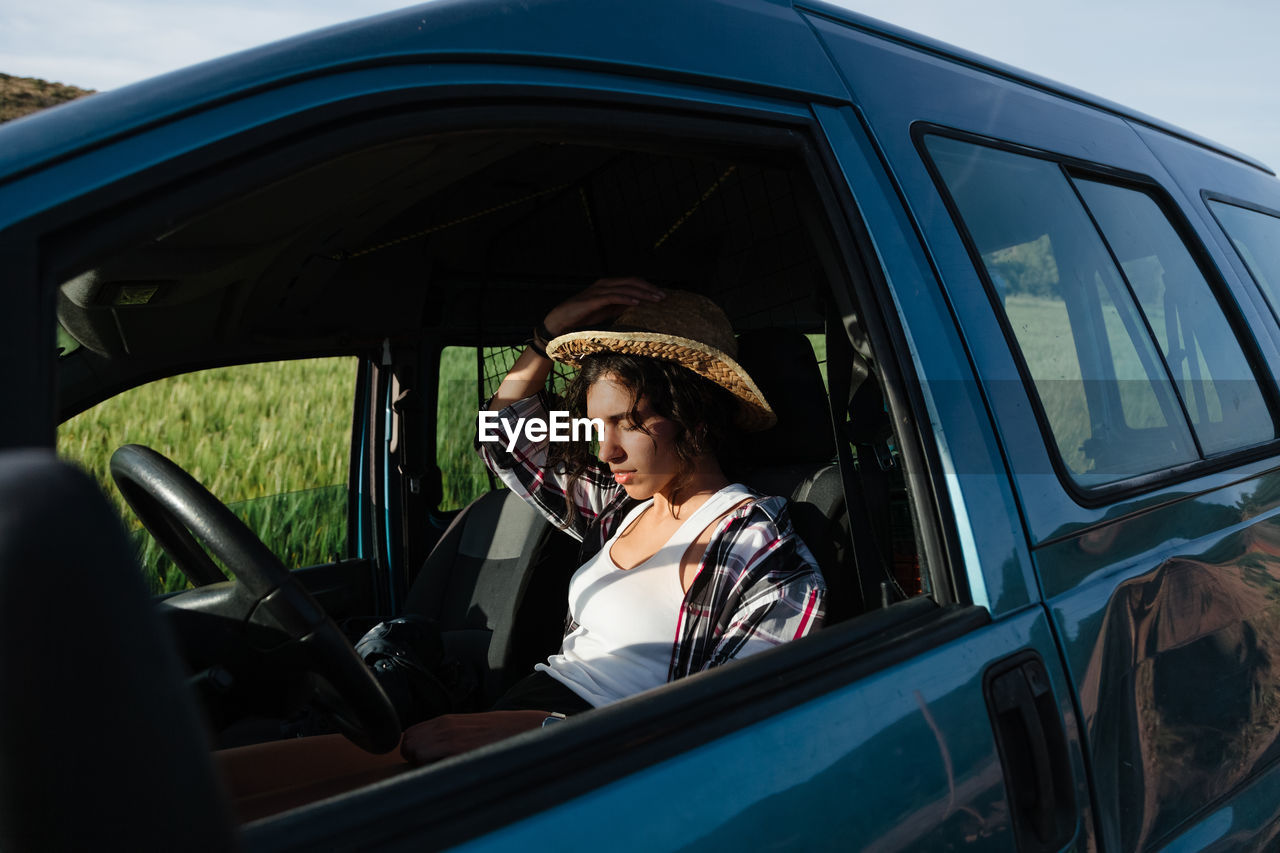 Young woman sitting in car