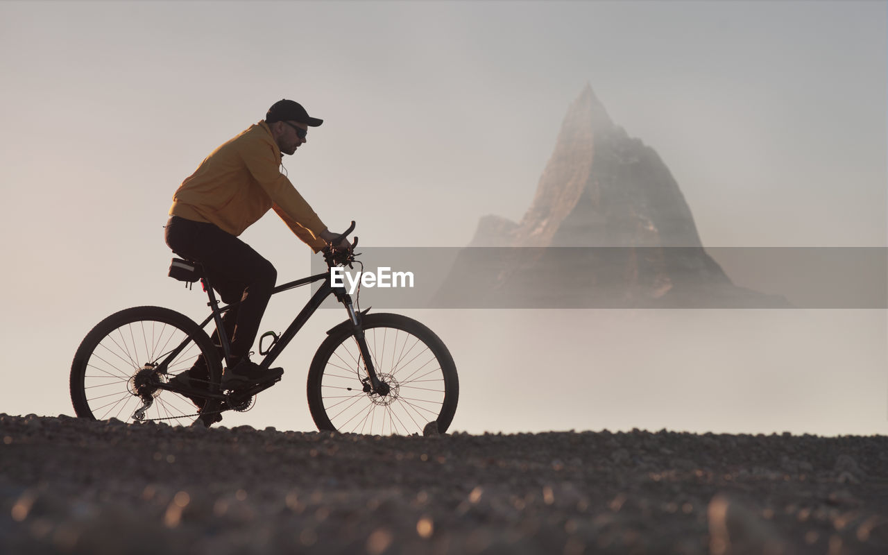 Man on a mountain bike rides in a picturesque mountainous area. active lifestyle theme