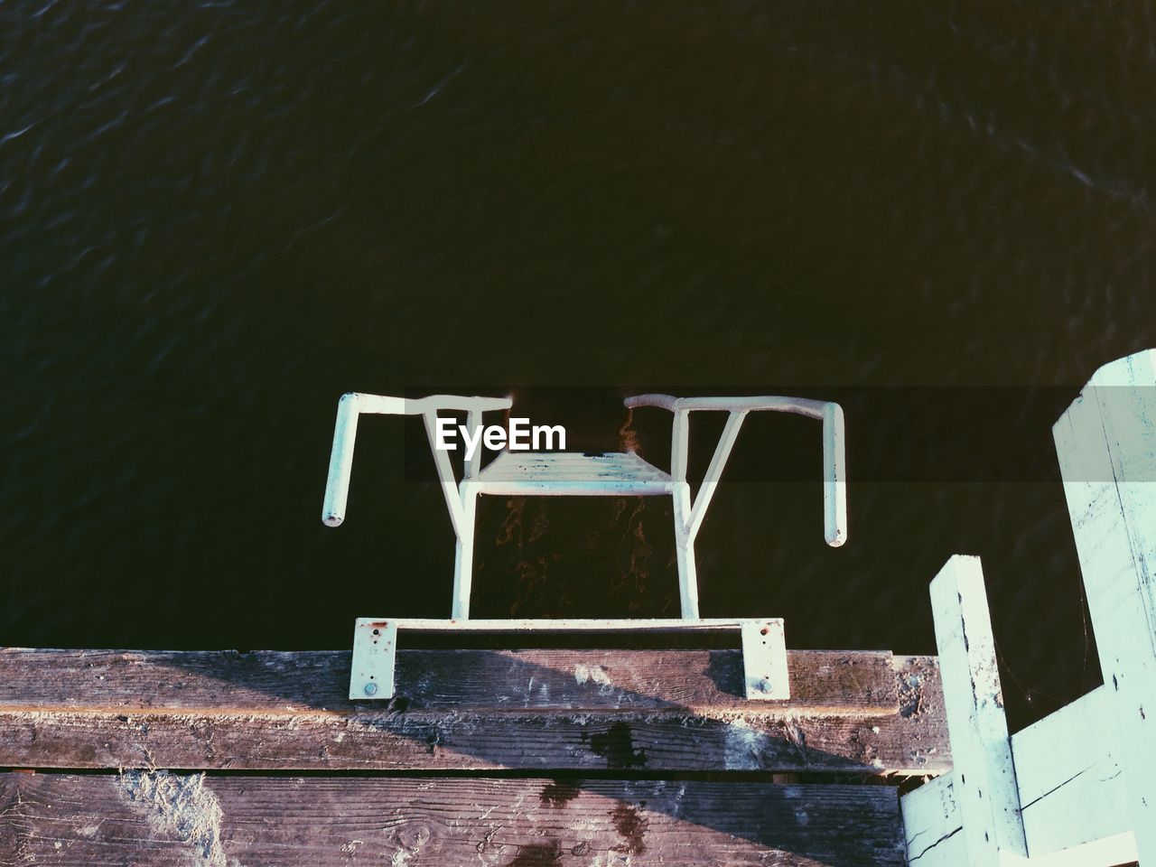 High angle view of ladder by pier at sea