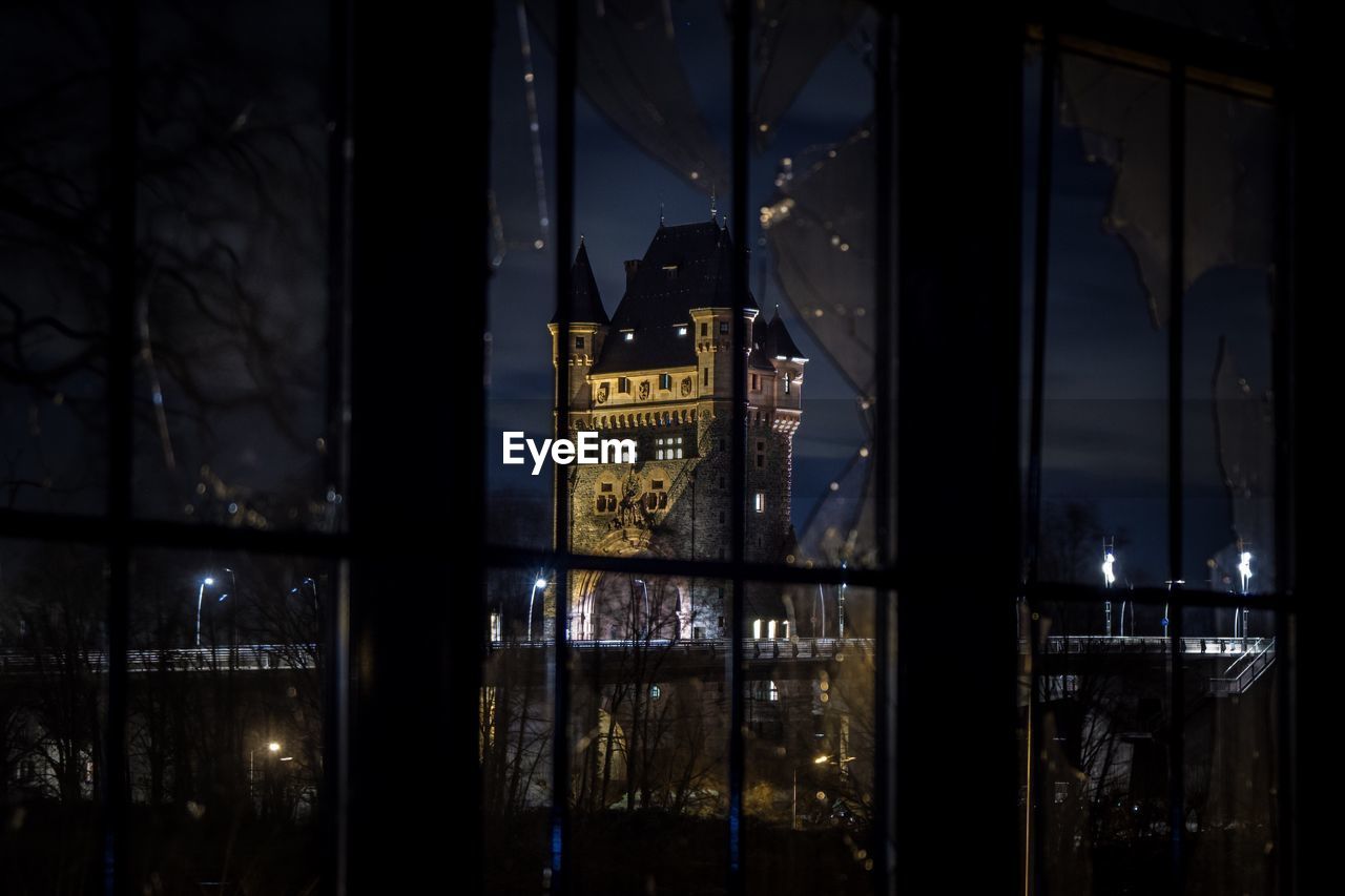 Reflection of illuminated buildings in city at night