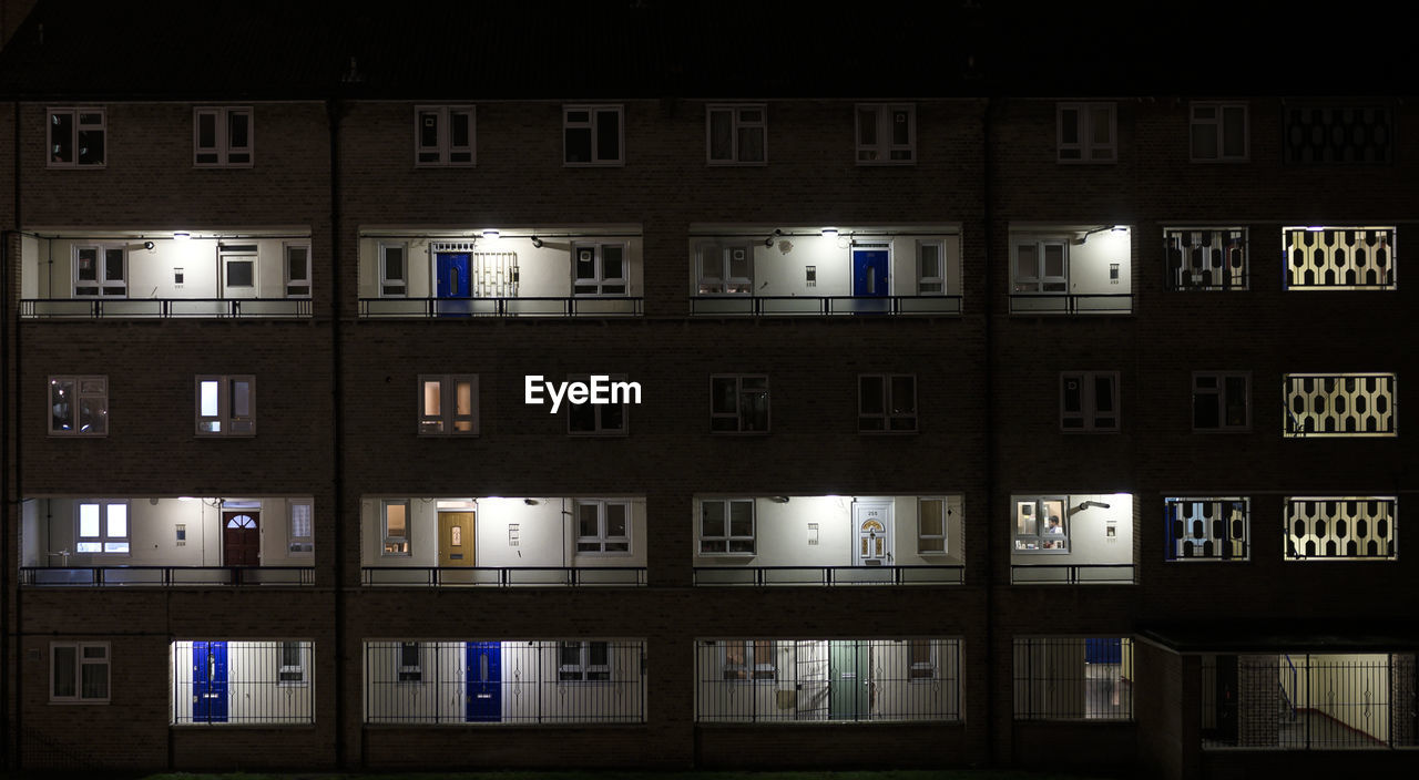 Reflection of illuminated building in city at night