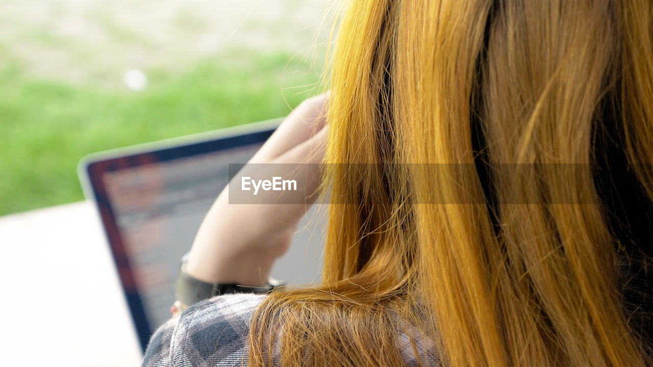 Close-up of young woman against blurred background