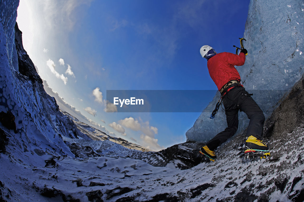 Mature man climbing at solheimajokull in south iceland