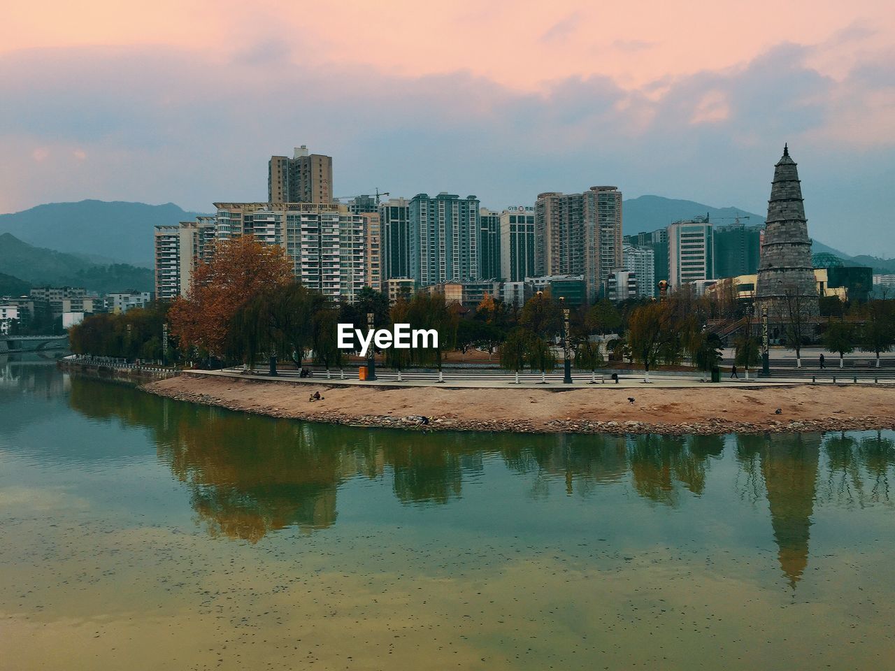 Reflection of buildings in city at waterfront