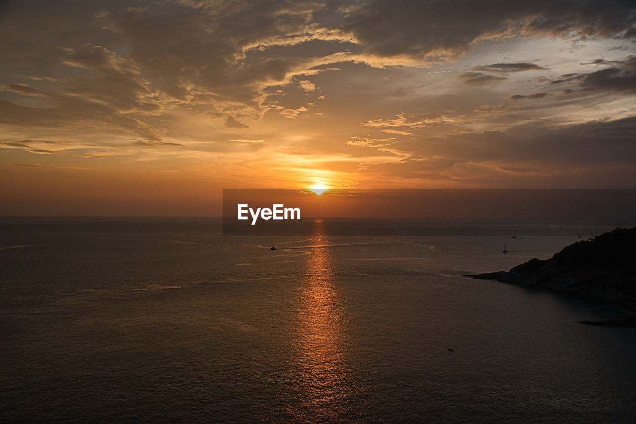 SCENIC VIEW OF SUNSET OVER SEA