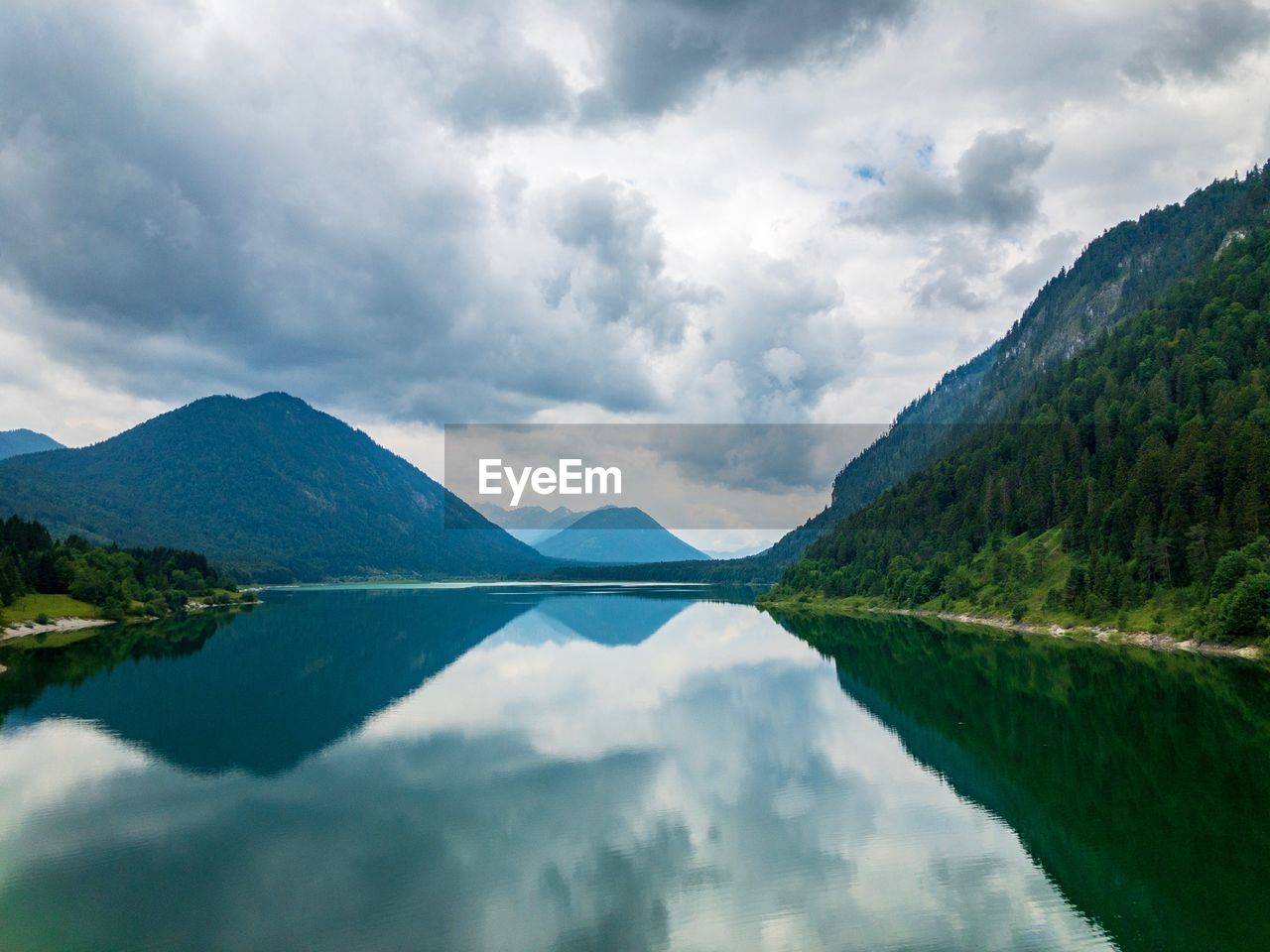 Scenic view of lake and mountains against sky