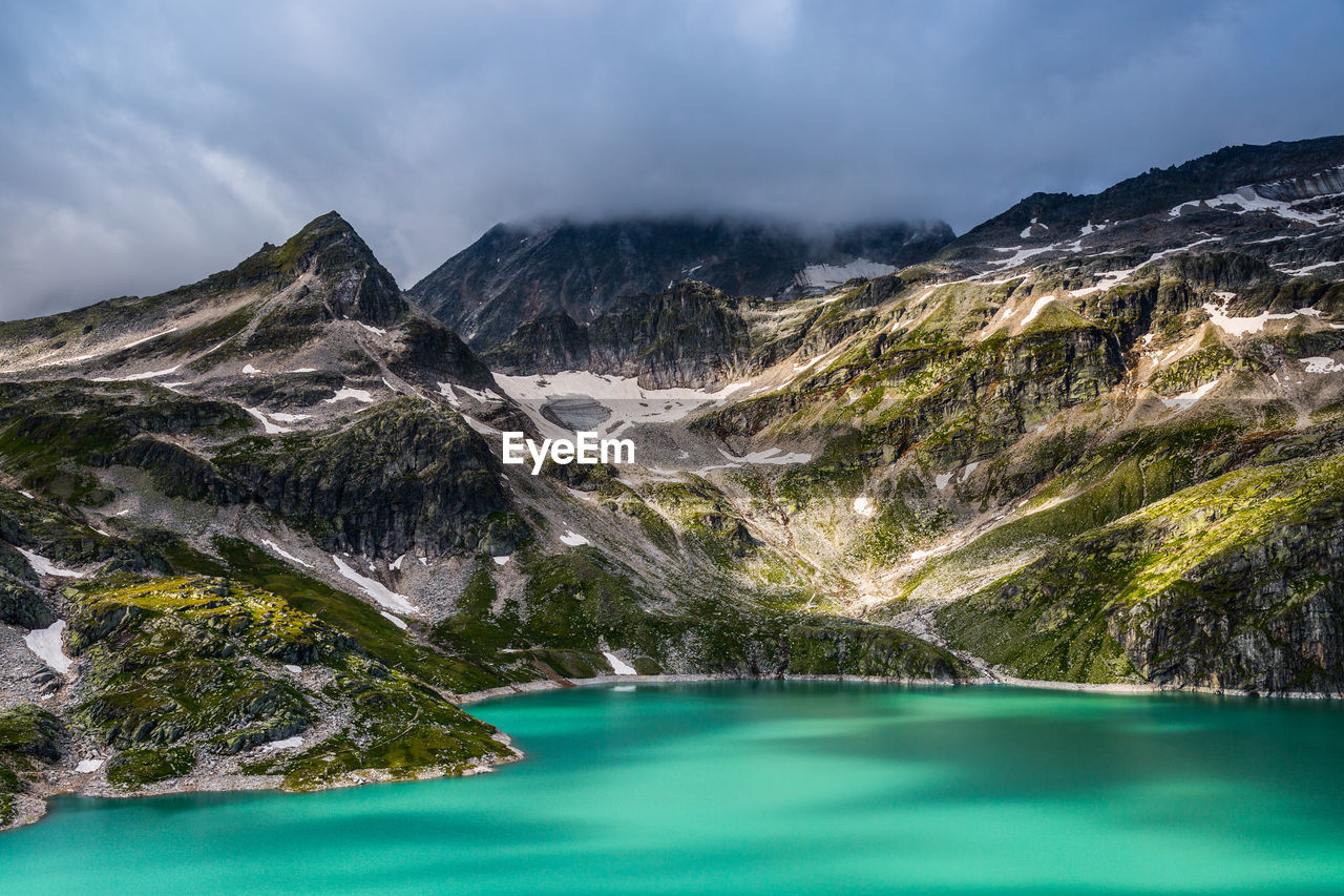 Scenic view of lake and mountains against sky