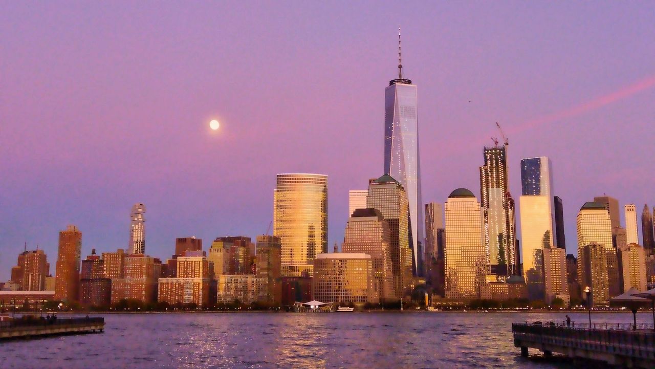 ILLUMINATED CITY AT WATERFRONT