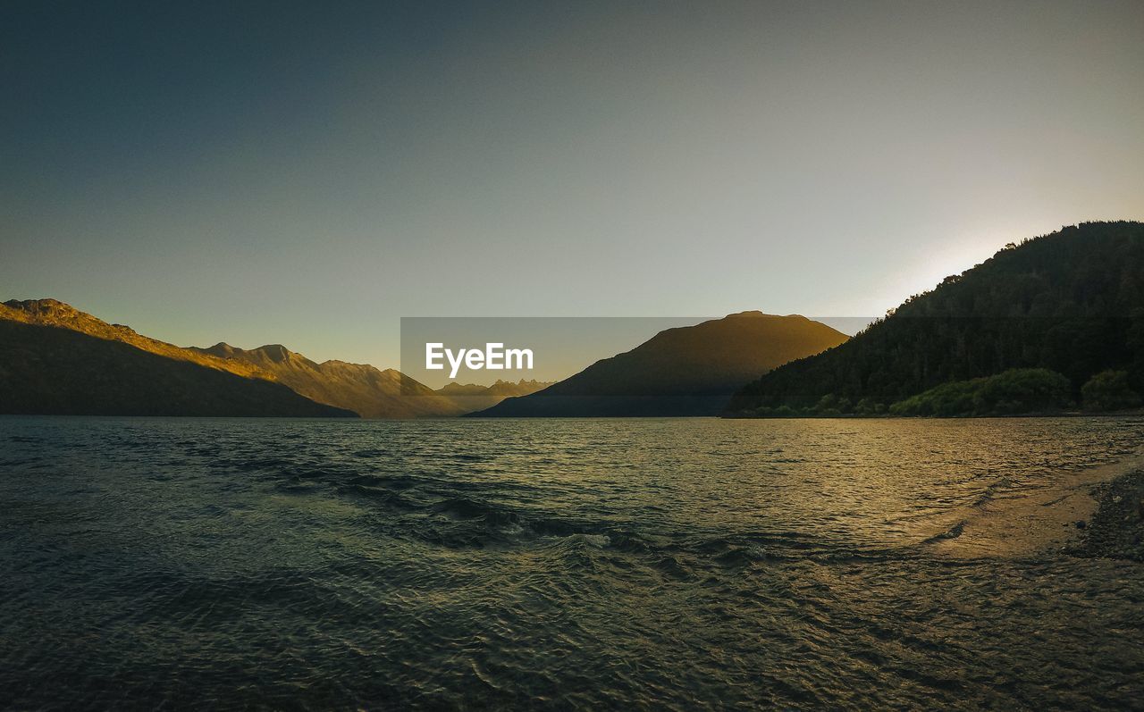 Scenic view of sea against clear sky during sunset