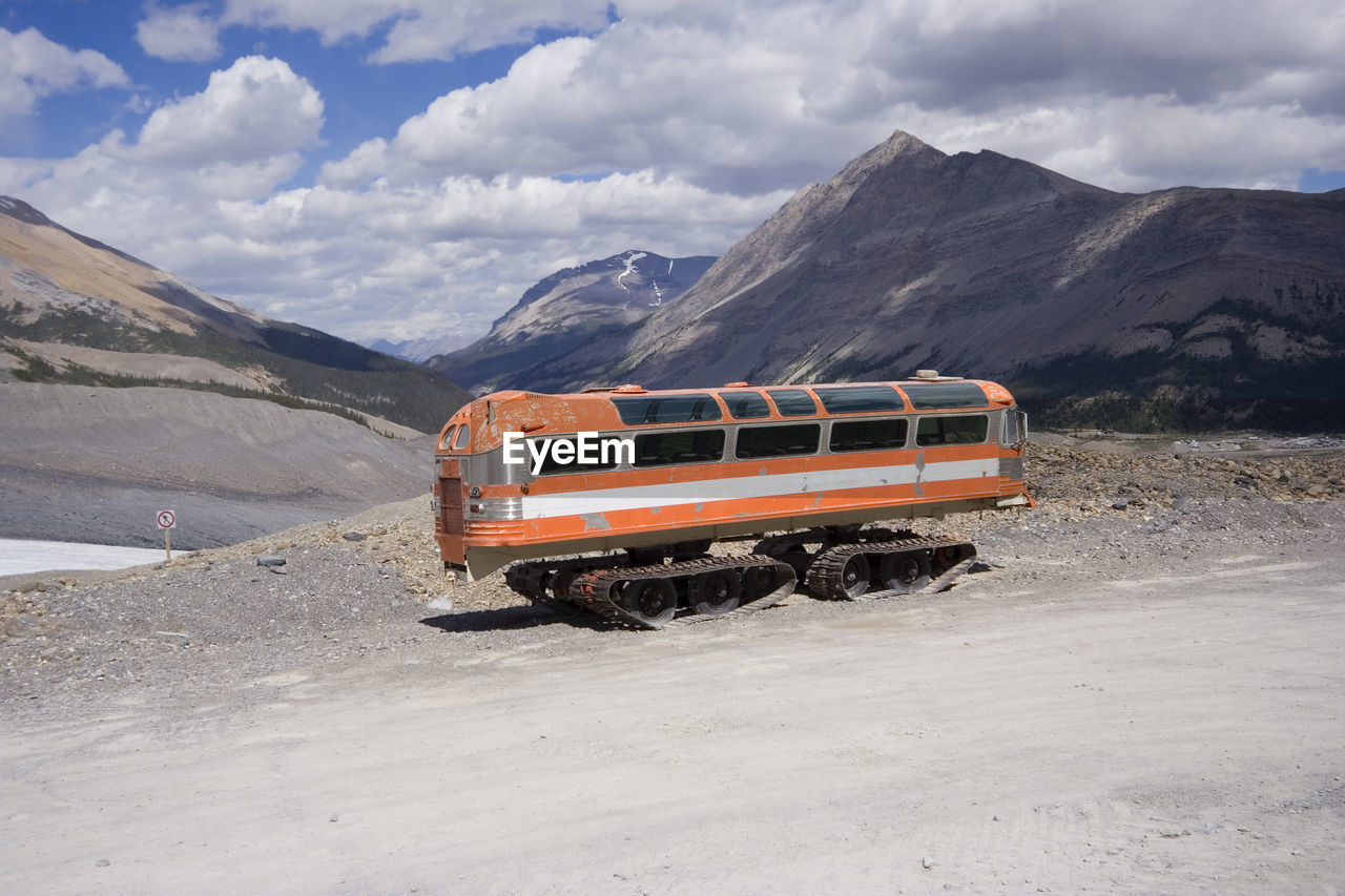 CAR ON SNOW COVERED LANDSCAPE