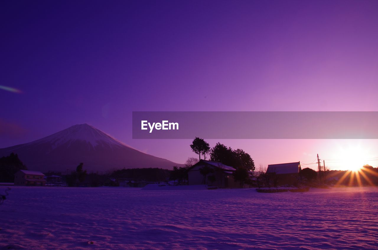 SCENIC VIEW OF LANDSCAPE AGAINST CLEAR SKY AT SUNSET