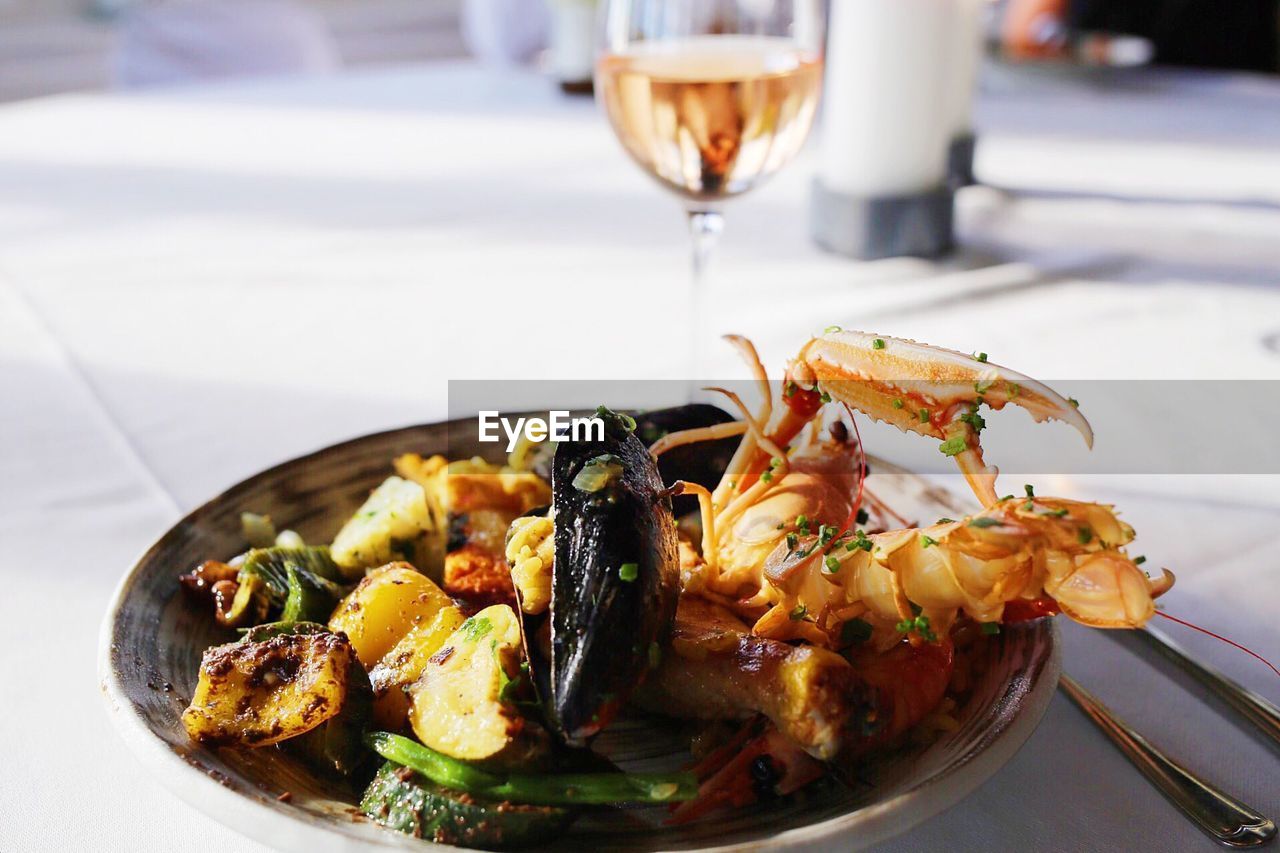 Close-up of paella served in plate on table in restaurant