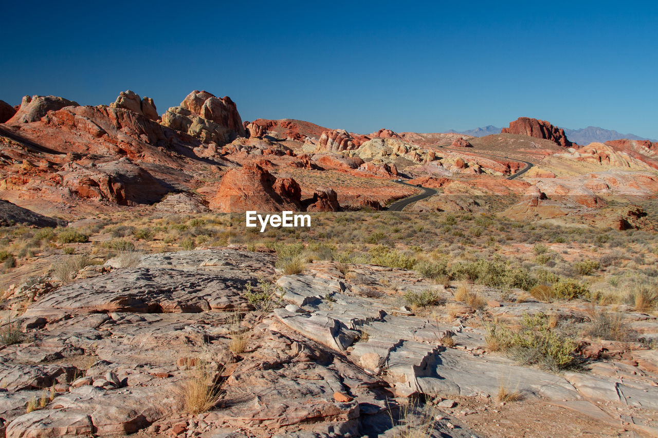 Scenic view of rocky mountains against blue sky