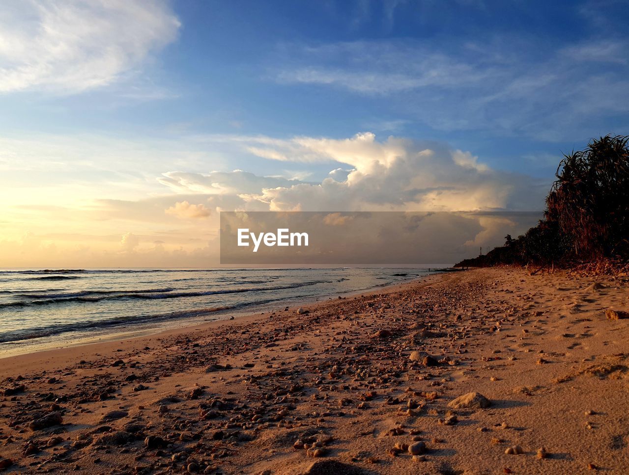 Scenic view of beach against sky during sunset