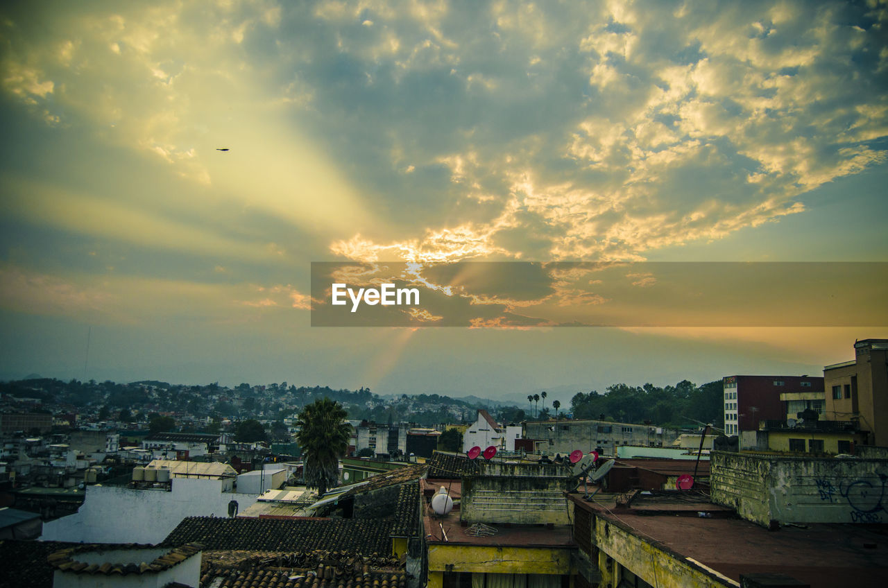 Aerial view of cityscape against sky during sunset