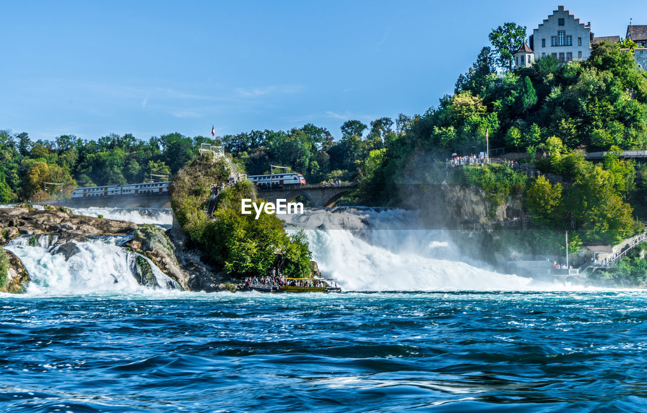 Scenic view of waterfall against sky