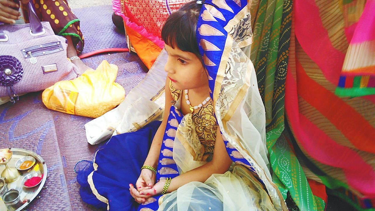 High angle view of cute girl sitting floor during wedding