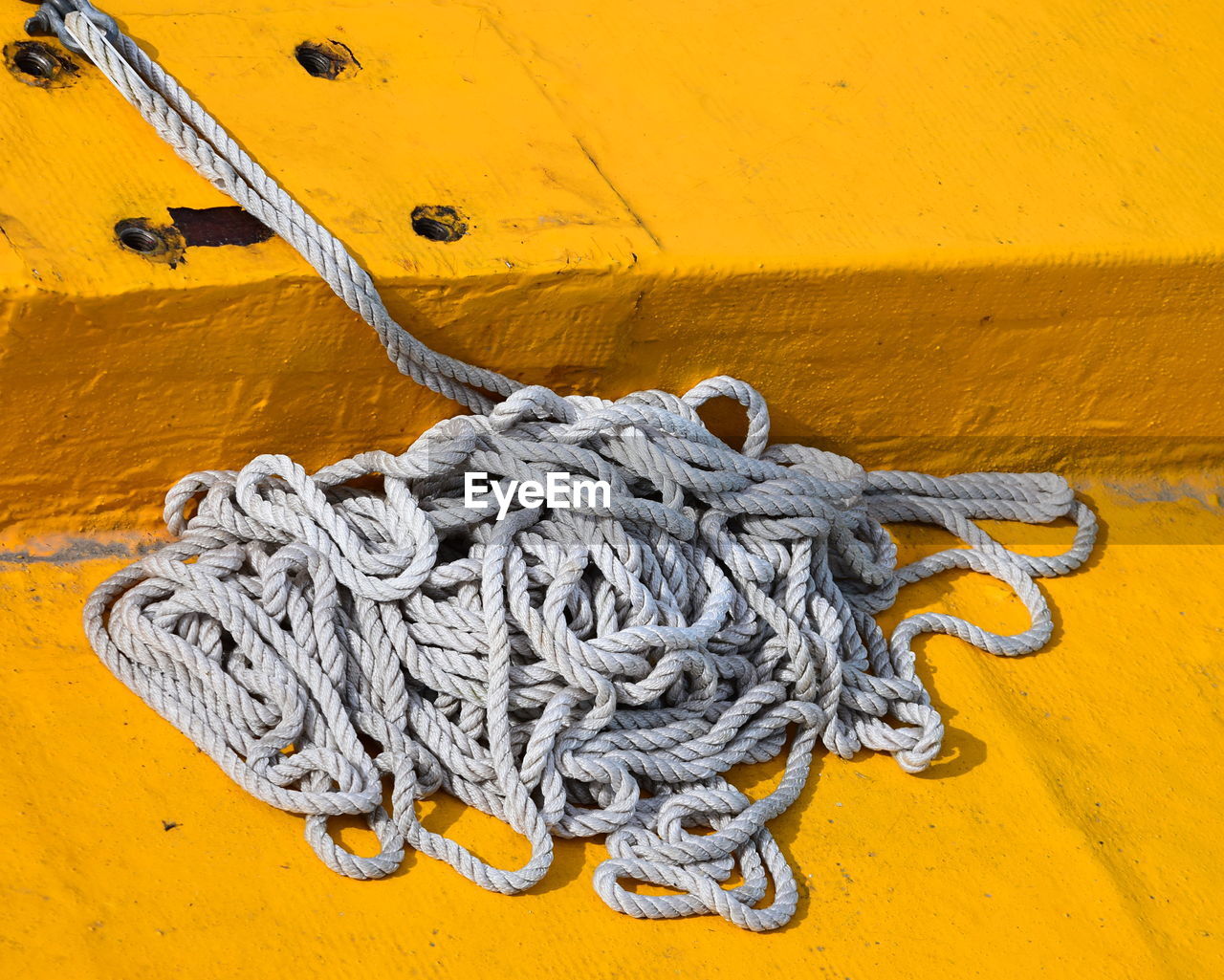 High angle view of rope on yellow pier