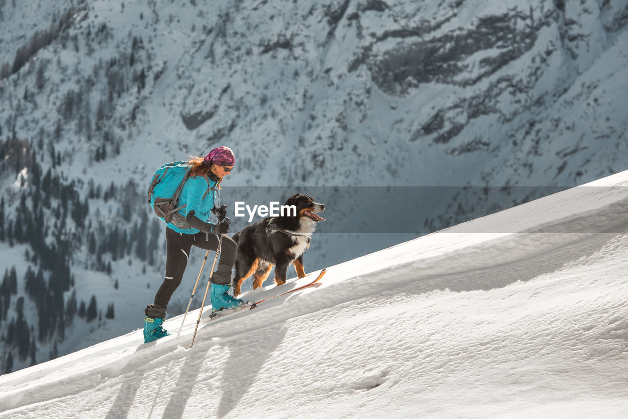rear view of people walking on snow