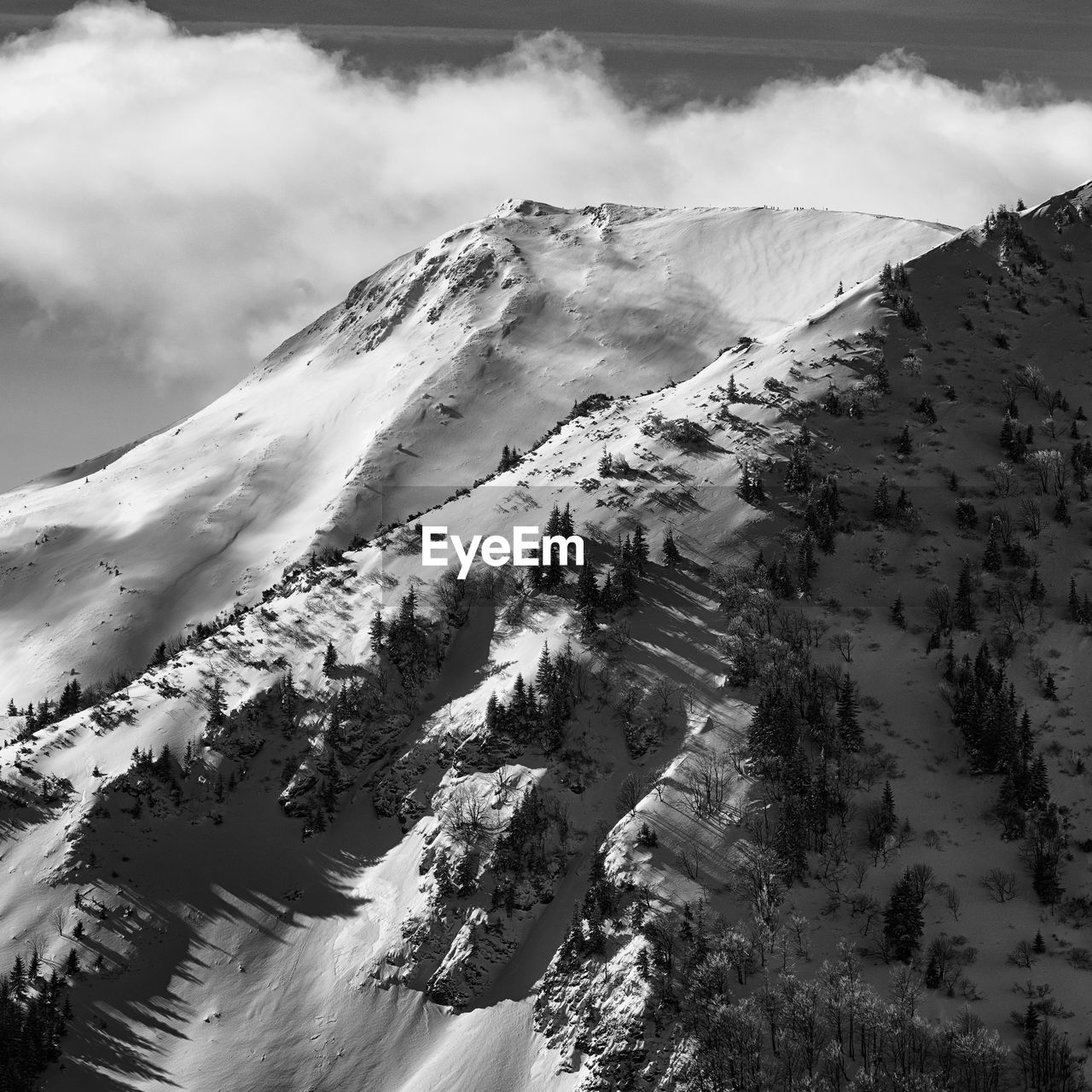 Aerial view of snow covered mountains against sky