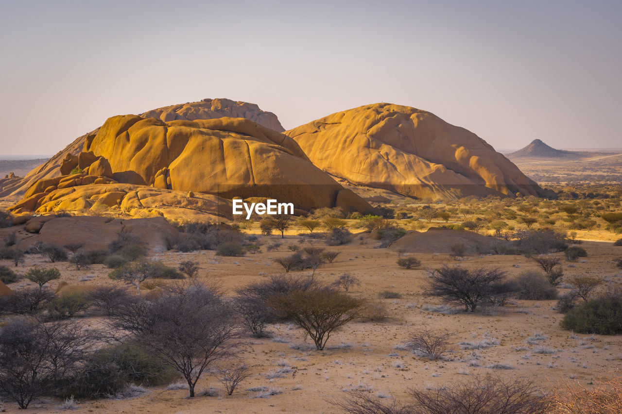 rock formations on landscape against clear sky