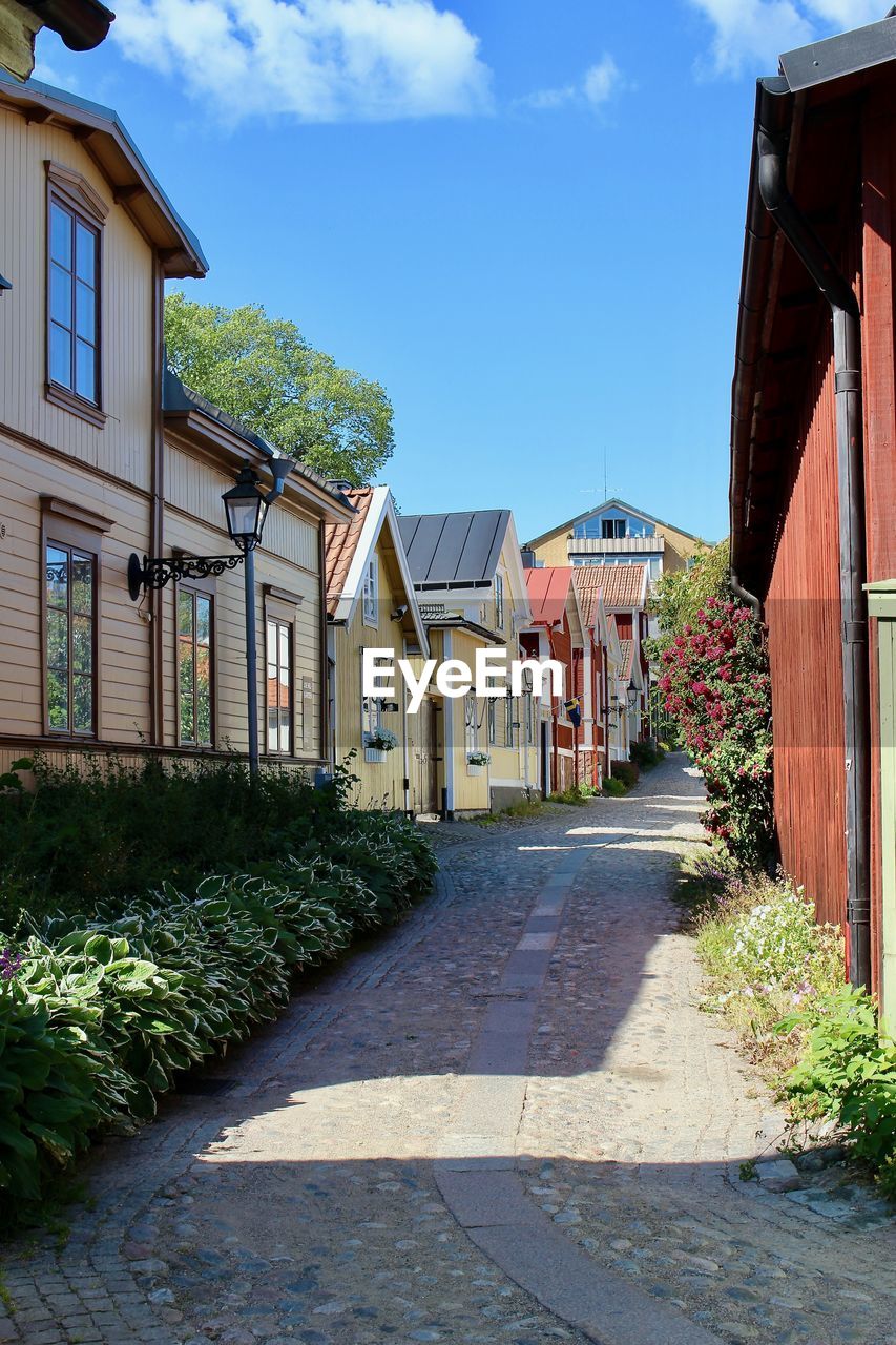 Street amidst buildings against sky