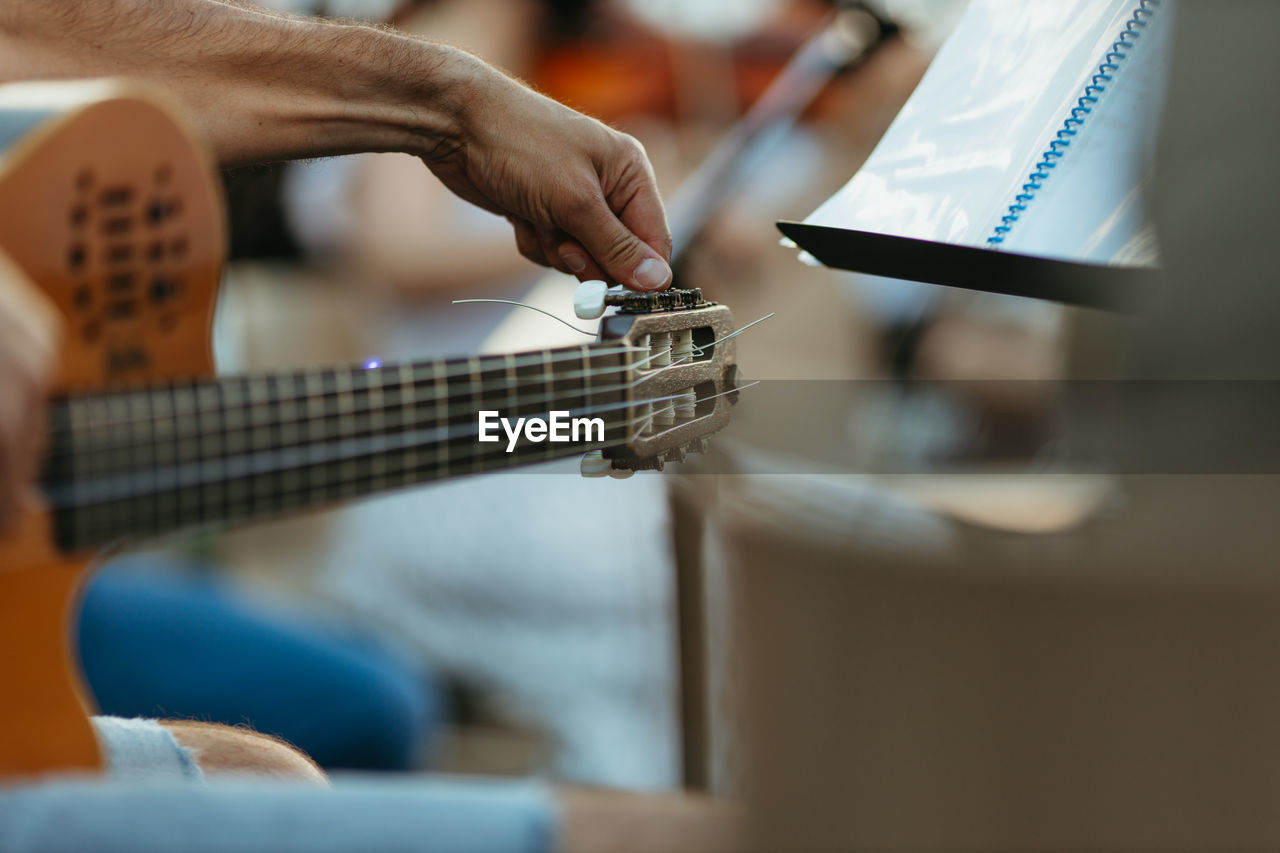 Close-up of person playing guitar