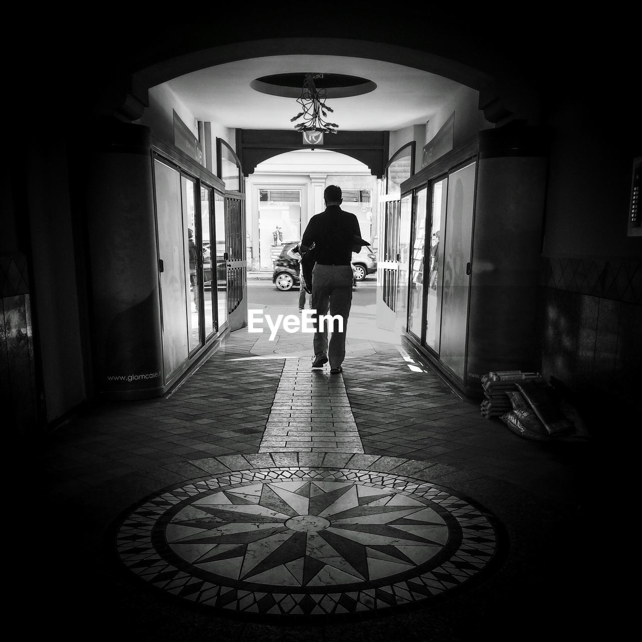 Rear view of a man walking on foyer