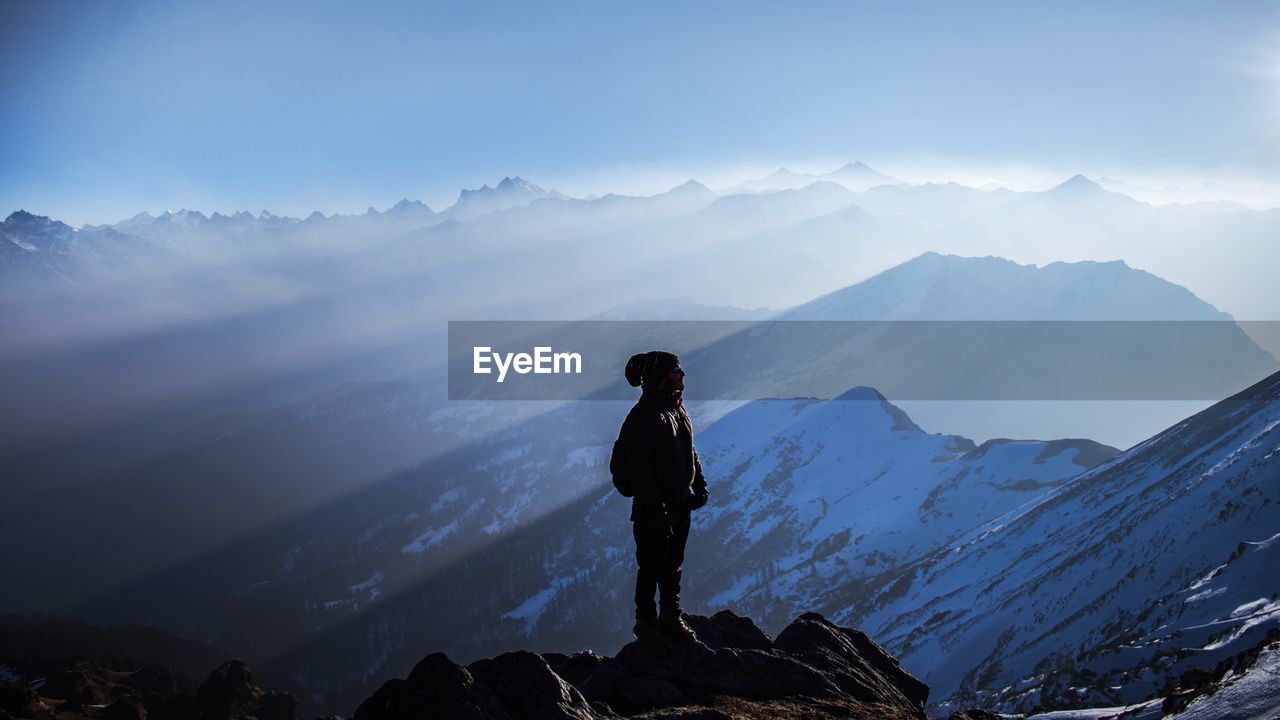 Man standing on mountain against sky