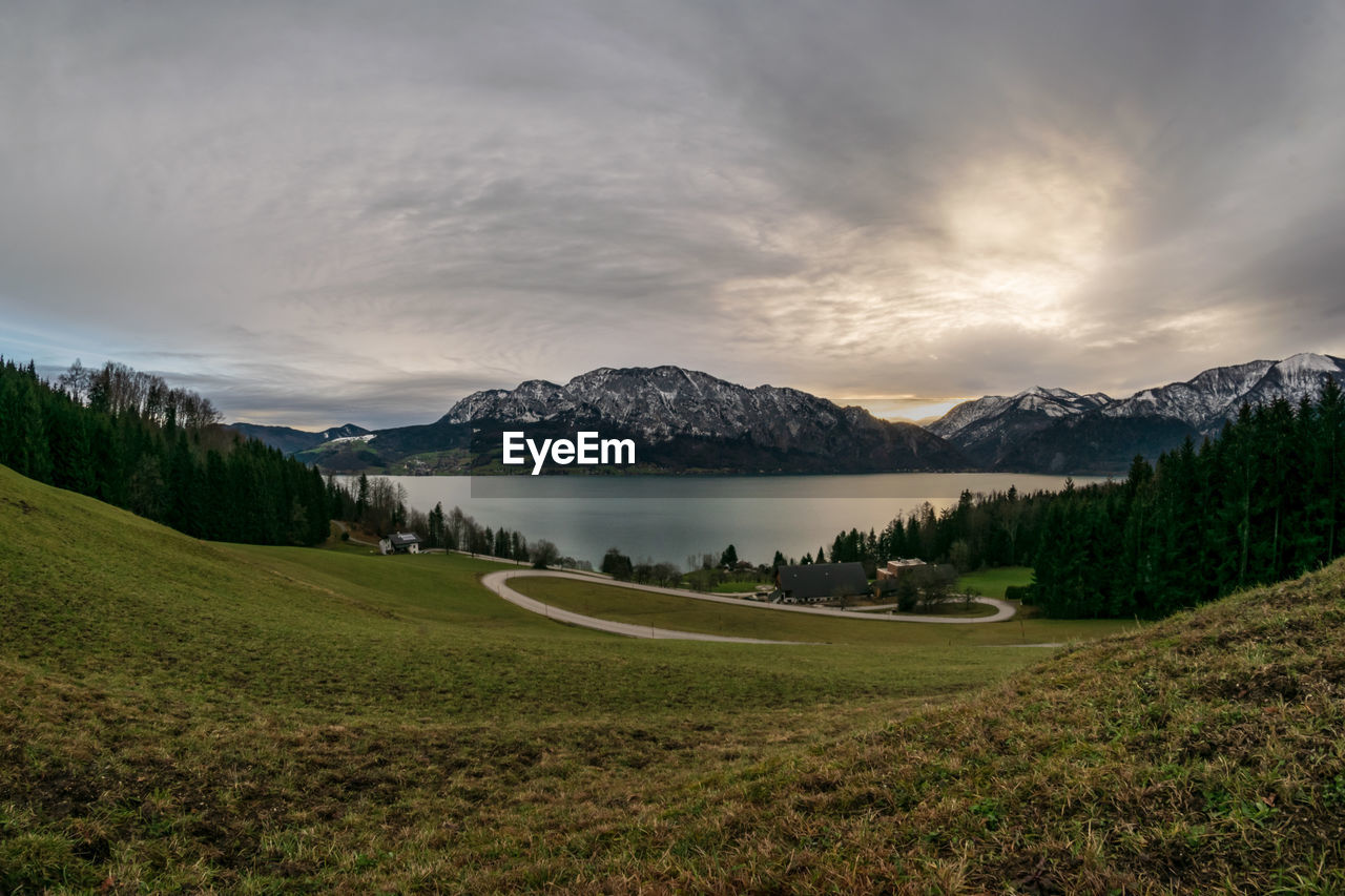 Scenic view of lake and mountains against sky