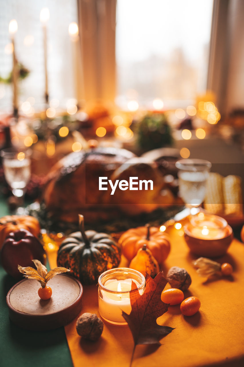 Close-up of lit candles on table