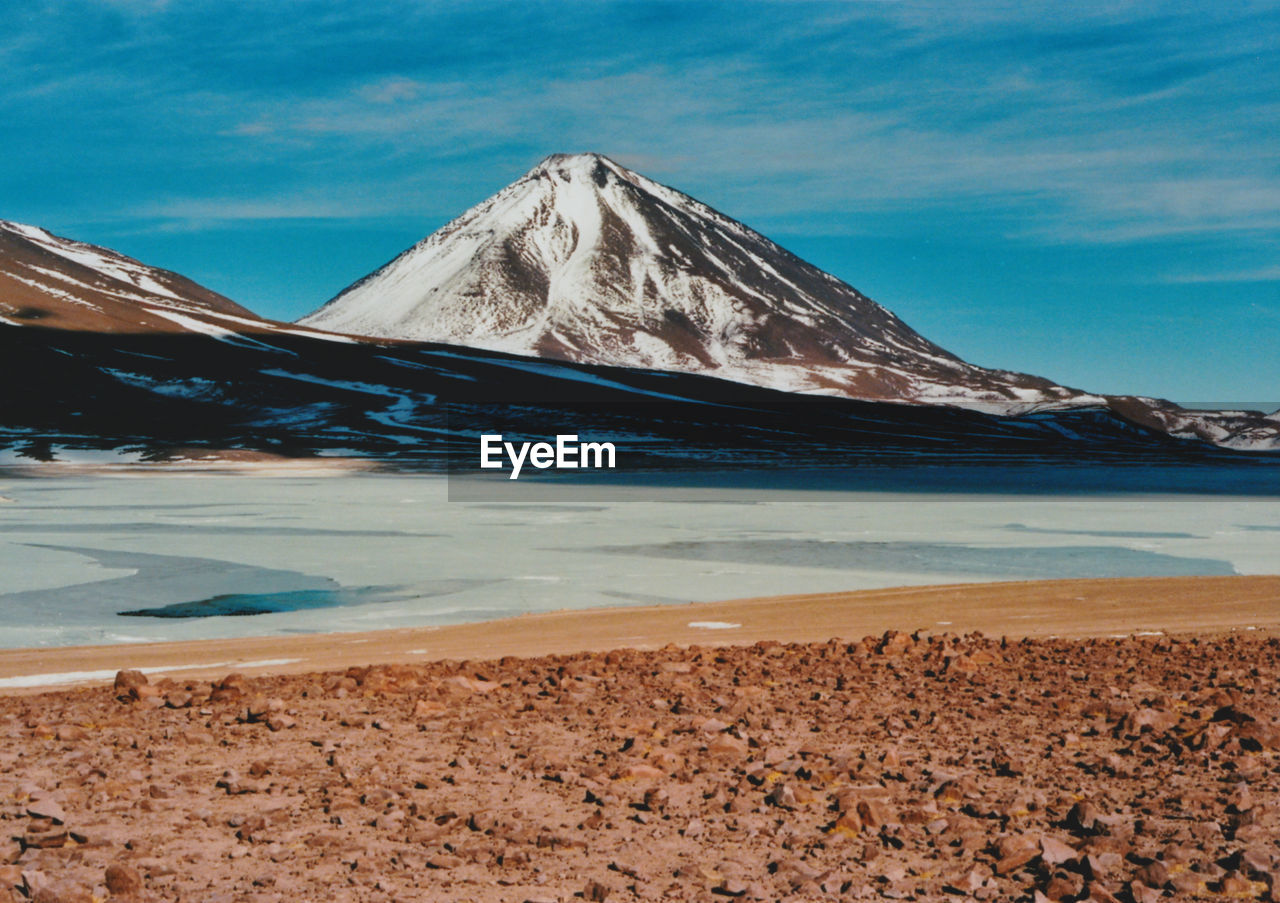 Scenic view of lake against cloudy sky