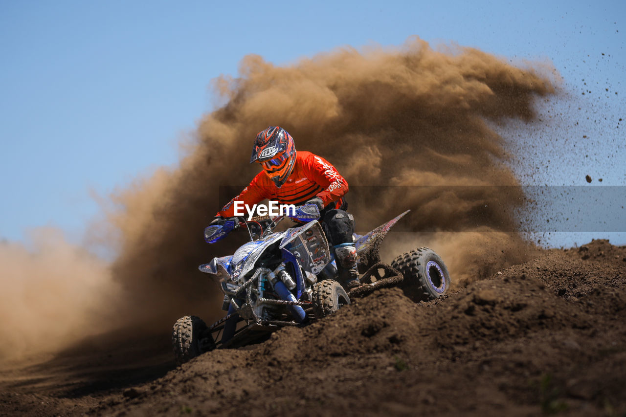 VIEW OF PERSON RIDING MOTORCYCLE ON CART