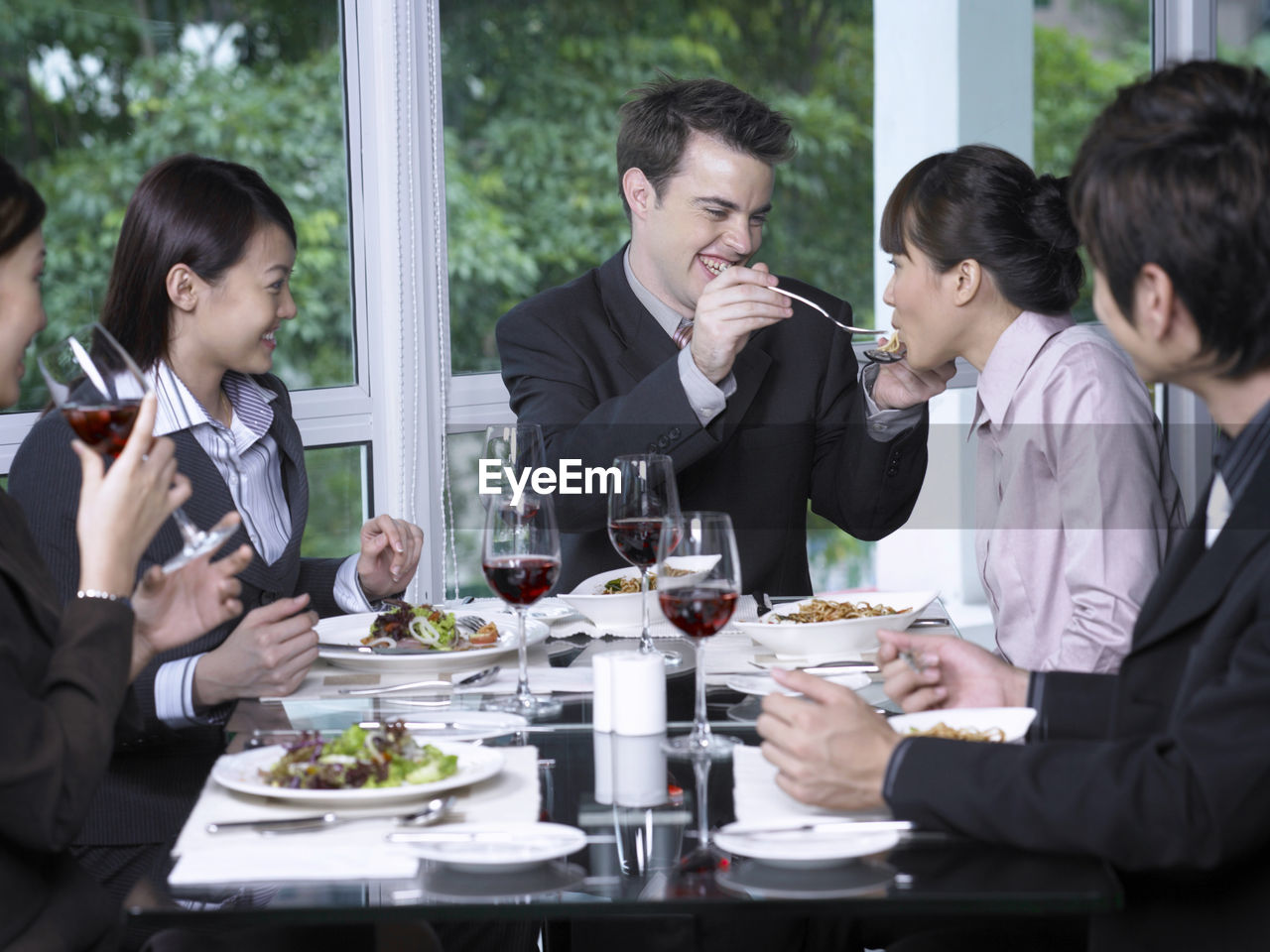 Colleagues with drinks at restaurant during meeting