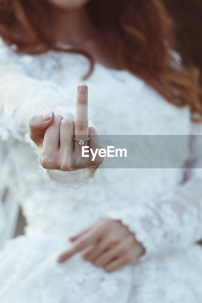 Close-up of bride showing ring finger